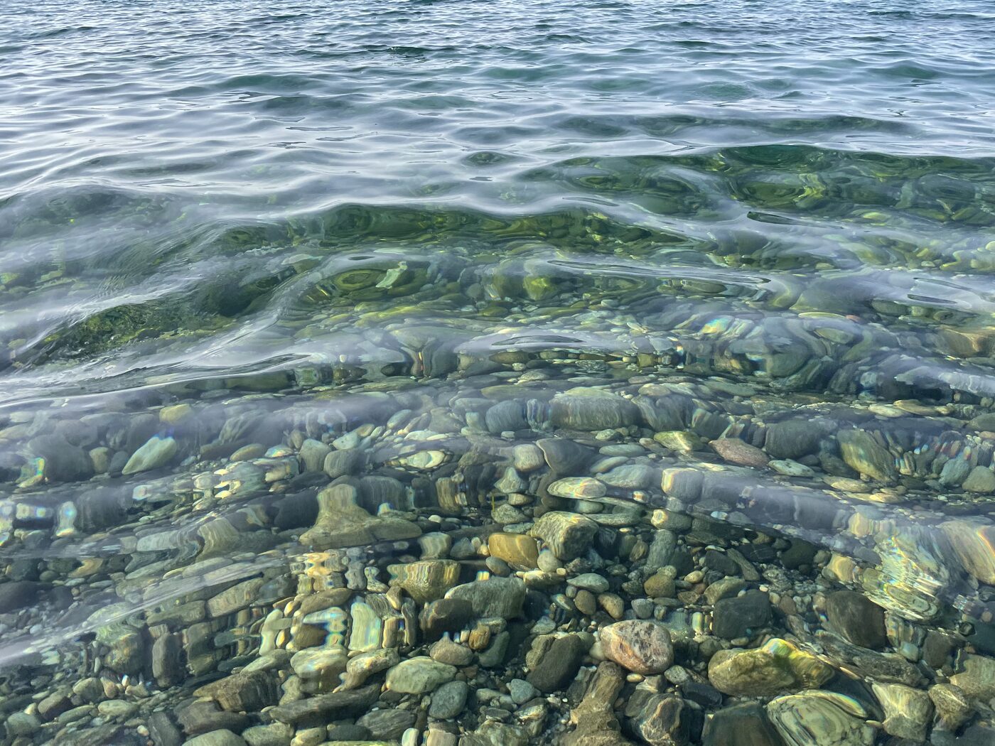 Clear sea water over smooth stones
